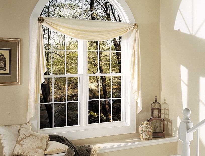Double hung windows paired with geometric shaped windows to create elegant style.